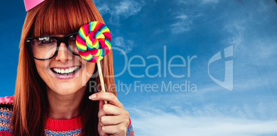Composite image of smiling hipster woman with lollipop and hat p