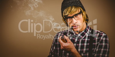 Composite image of serious blond hipster smoking a pipe