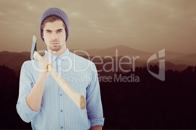 Composite image of portrait of serious hipster holding axe on sh