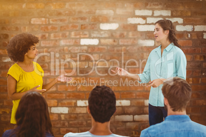 Composite image of casual young businesswoman giving presentatio