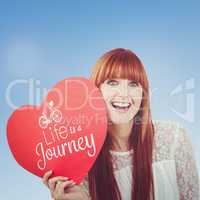 Composite image of smiling hipster woman with a big red heart