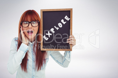 Composite image of smiling hipster woman holding blackboard