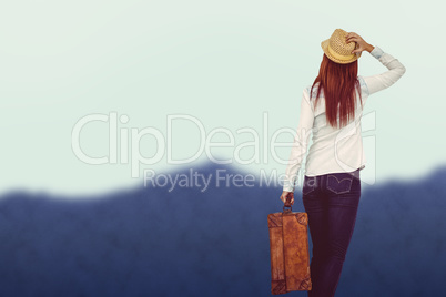 Composite image of rear view of hipster woman holding suitcase