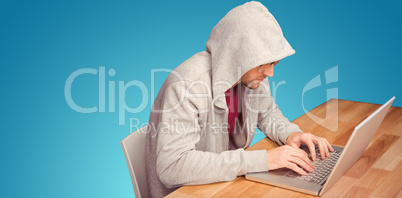 Composite image of businessman with hooded shirt working on lapt