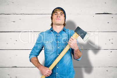 Composite image of front view of hipster standing with axe