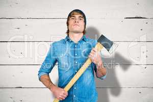 Composite image of front view of hipster standing with axe