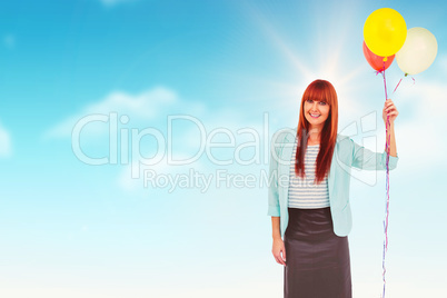 Composite image of smiling hipster woman holding balloons