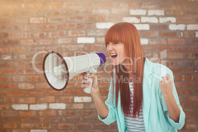 Composite image of hipster woman shooting through megaphone