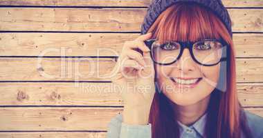 Composite image of smiling hipster woman looking at camera