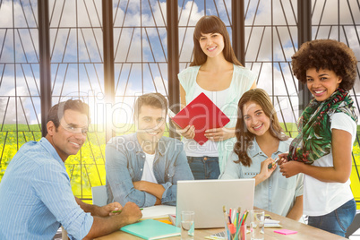 Composite image of smiling casual colleagues in a meeting