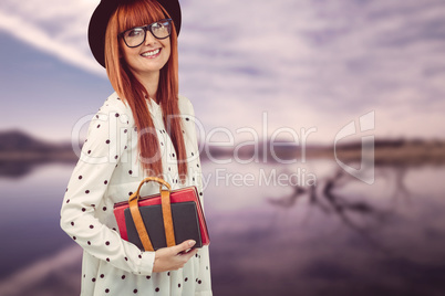 Smiling hipster woman holding book belt