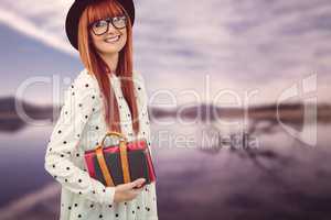 Smiling hipster woman holding book belt