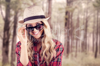 Gorgeous smiling blonde hipster posing with sunglasses