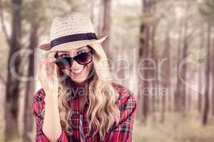 Gorgeous smiling blonde hipster posing with sunglasses