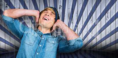 Composite image of cheerful hipster listening to music