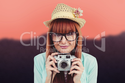 Composite image of portrait of a smiling hipster woman holding r