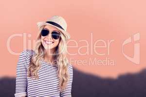 Composite image of gorgeous smiling blonde hipster with sunglass