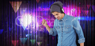 Composite image of hipster wearing headphones enjoying music