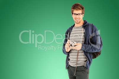 Composite image of portrait of happy man with camera