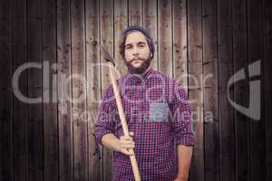 Composite image of portrait of hipster holding axe