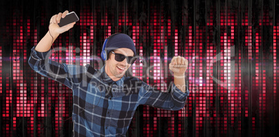 Composite image of portrait of happy hipster wearing headphones