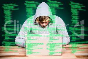 Composite image of  man in hood jacket hacking a laptop