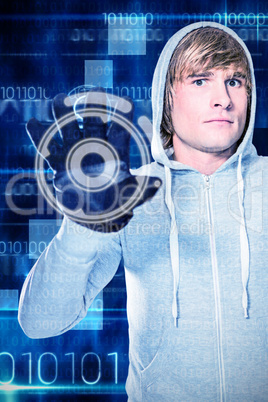 Composite image of man with black gloves staring at camera