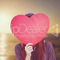 Composite image of hipster woman behind a red heart