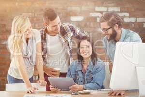 Composite image of cheerful business professionals using digital