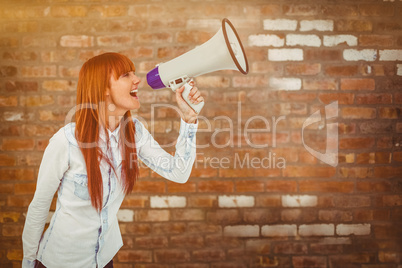 Composite image of hipster smiling woman through megaphone