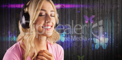 Composite image of close up of a woman listening to music