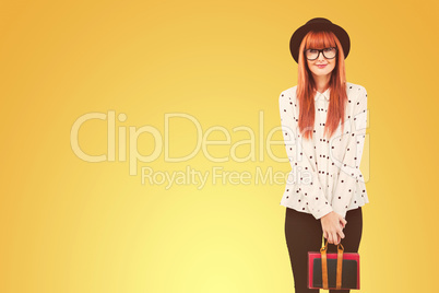 Composite image of smiling hipster woman holding book belt