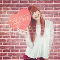 Composite image of smiling hipster woman with a big red heart
