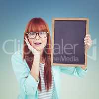 Composite image of smiling hipster woman holding blackboard