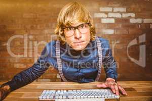 Composite image of hipster businessman looking closely the camer