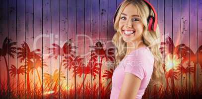 Composite image of portrait of a beautiful young woman with headphones
