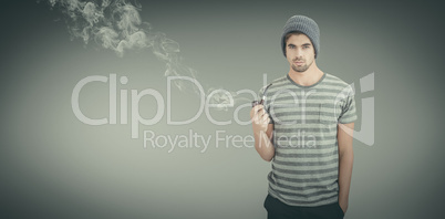 Composite image of portrait of man holding smoking pipe