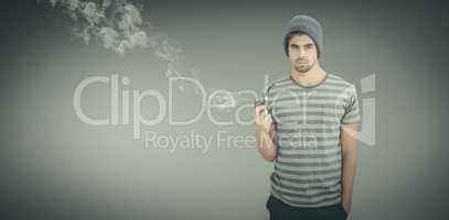 Composite image of portrait of man holding smoking pipe