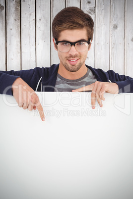 Composite image of portrait of man wearing eyeglasses pointing o