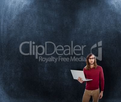 Composite image of portrait of creative businessman holding lapt