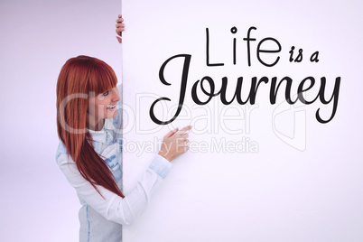 Composite image of smiling hipster woman behind a white card