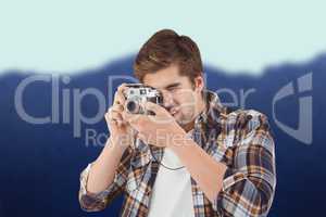 Composite image of hipster photographing against wooden wall