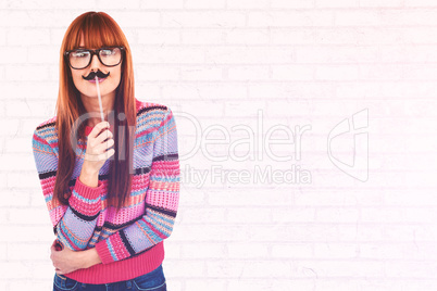 Composite image of smiling hipster woman with a mustache