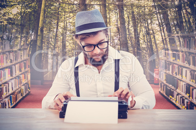 Composite image of hipster wearing eye glasses and hat working o