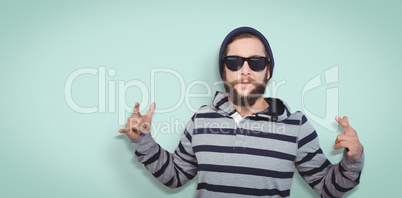 Composite image of hipster showing rock and roll hand sign