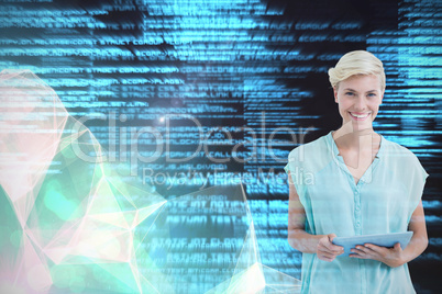 Composite image of woman standing with tablet