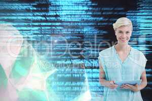 Composite image of woman standing with tablet