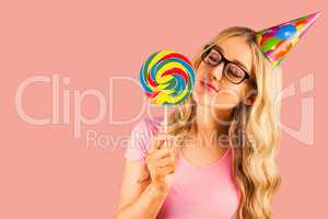 Composite image of a beautiful hipster holding a giant lollipop