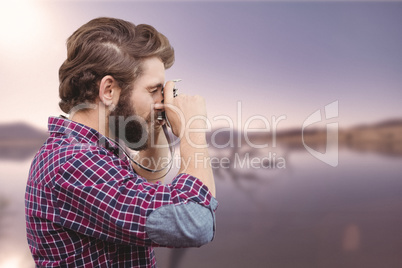 Composite image of side view of hipster photographing with camer