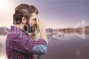 Composite image of side view of hipster photographing with camer